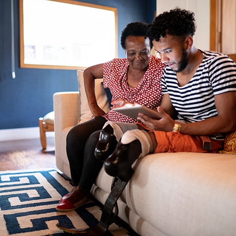 African American people looking on tablet computer
