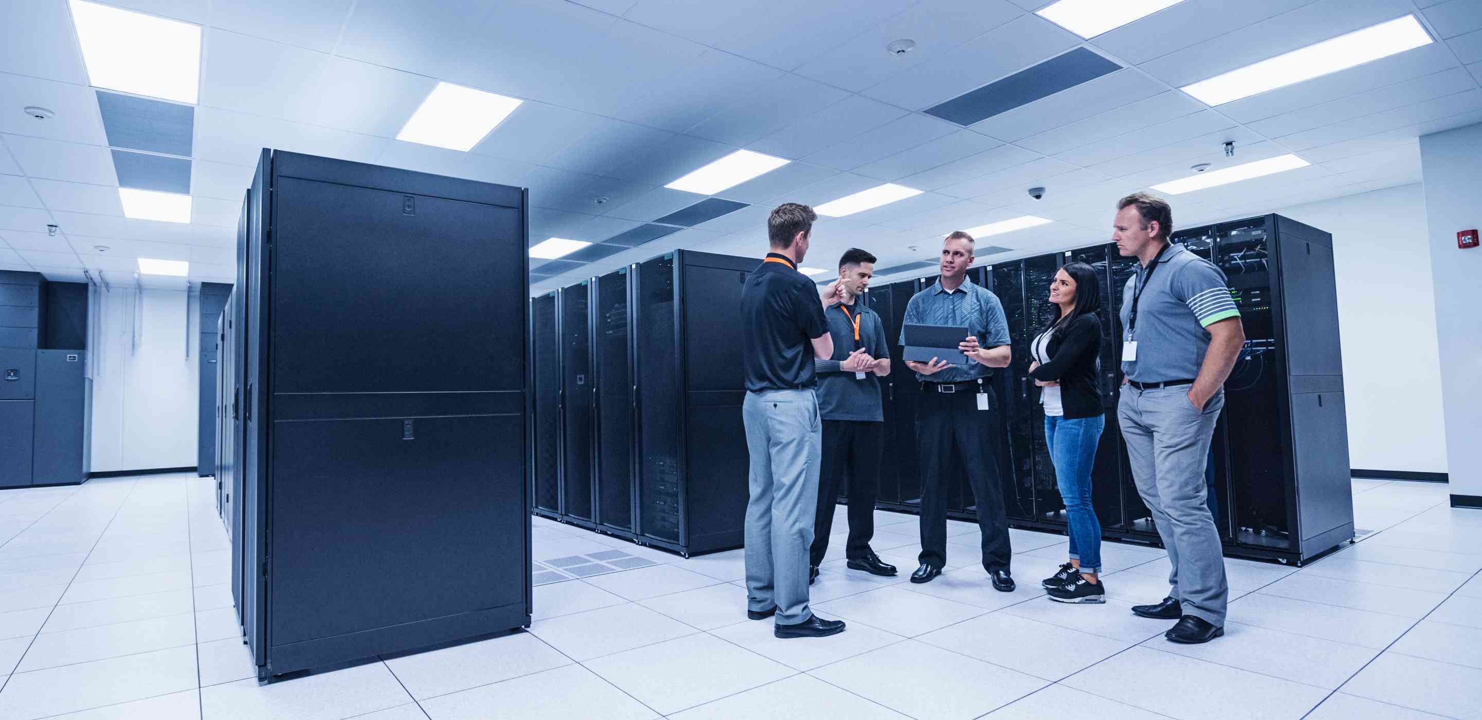A group of people standing in a server room