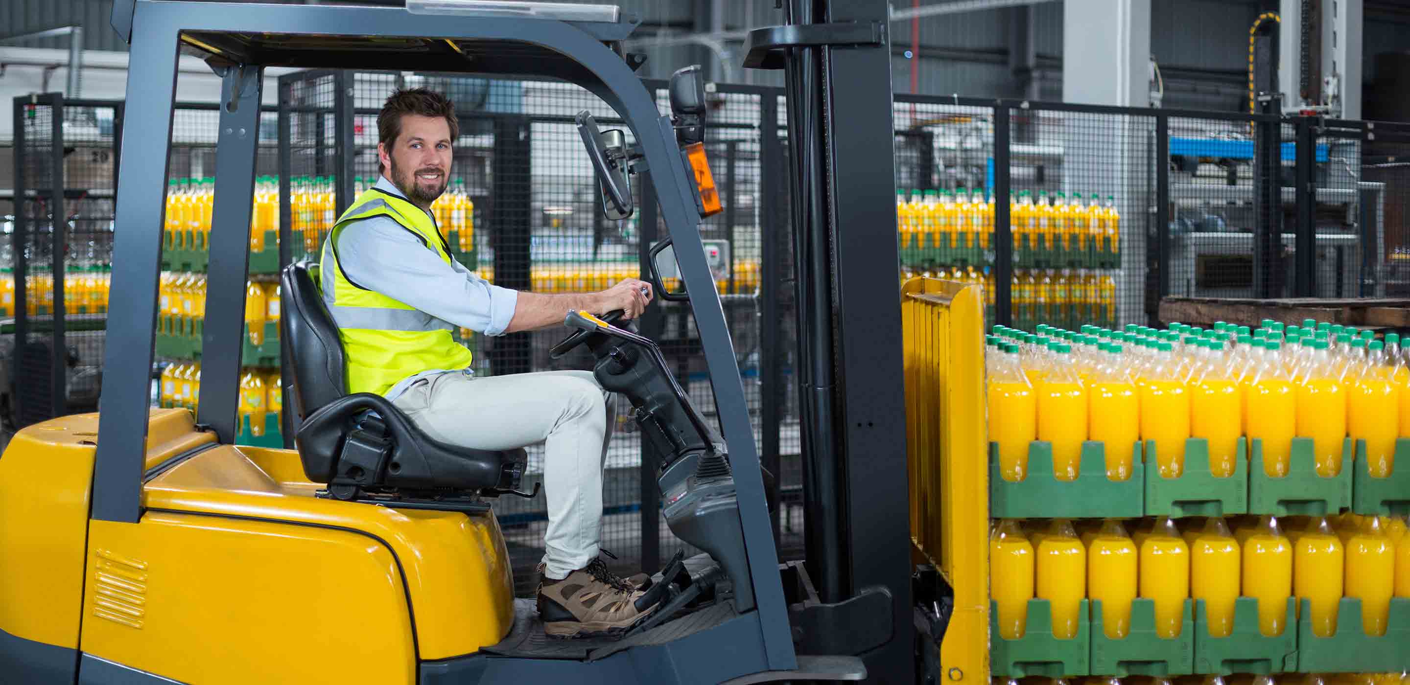 Man driving a forklift in a storage area