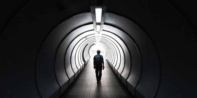 A person walking down a tunnel