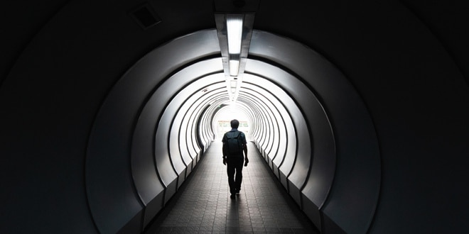 A person walking down a tunnel