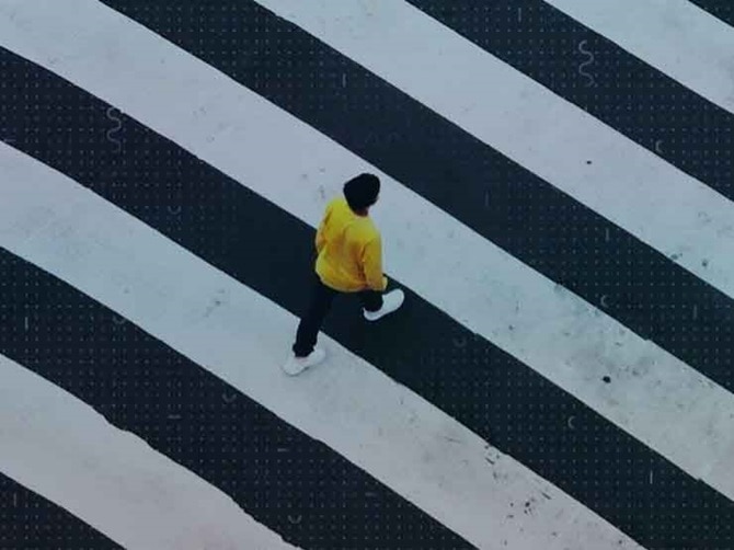A person walking over a road crossing