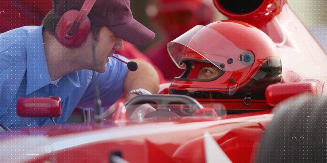 Formula 1 driver talking to a crew member