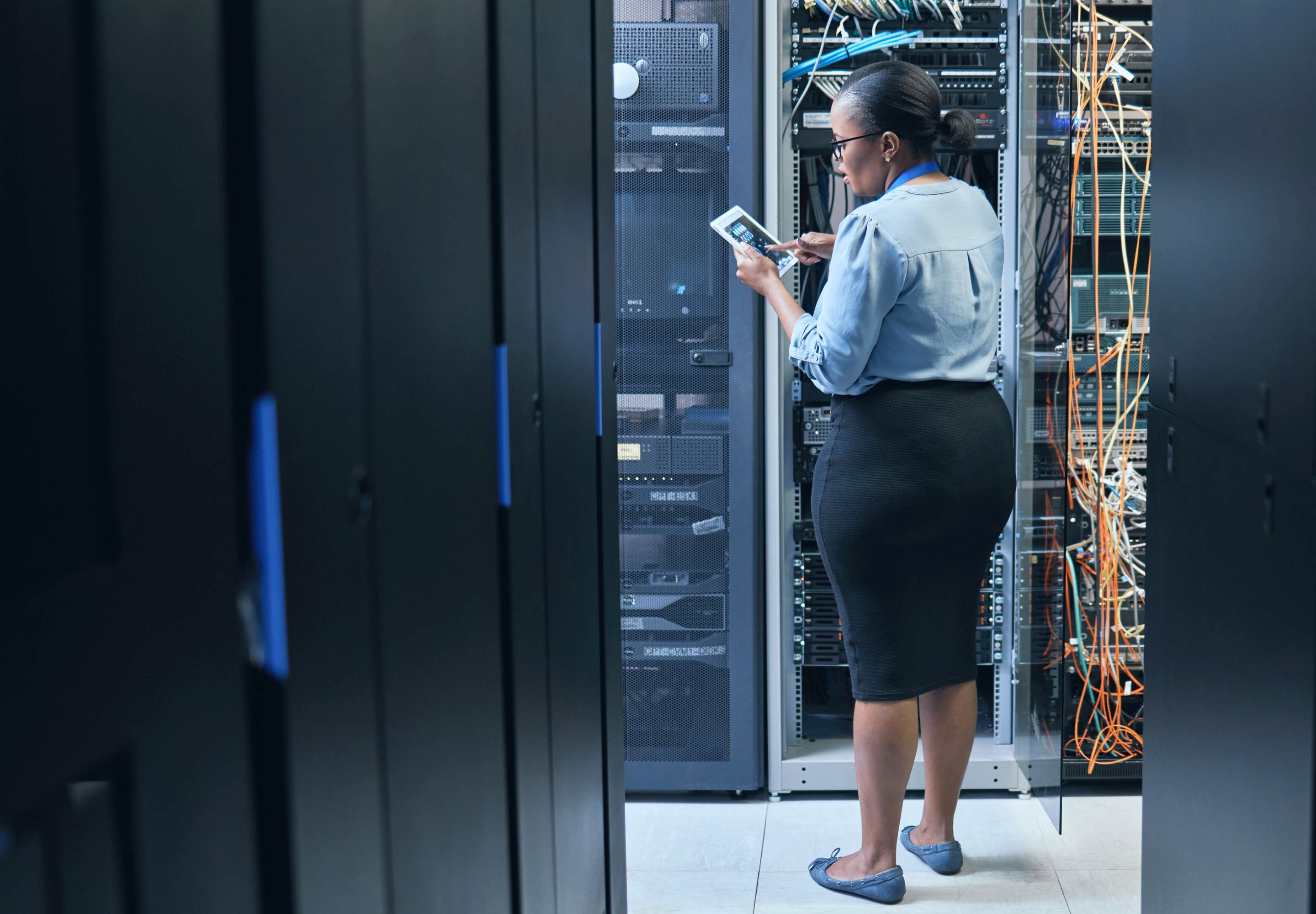 Lady standing in a server room
