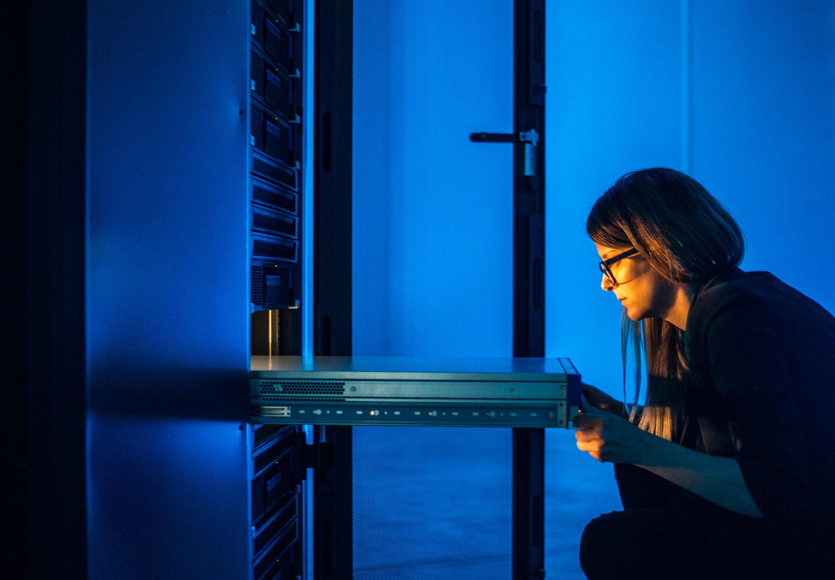 Lady working in the Data Center room