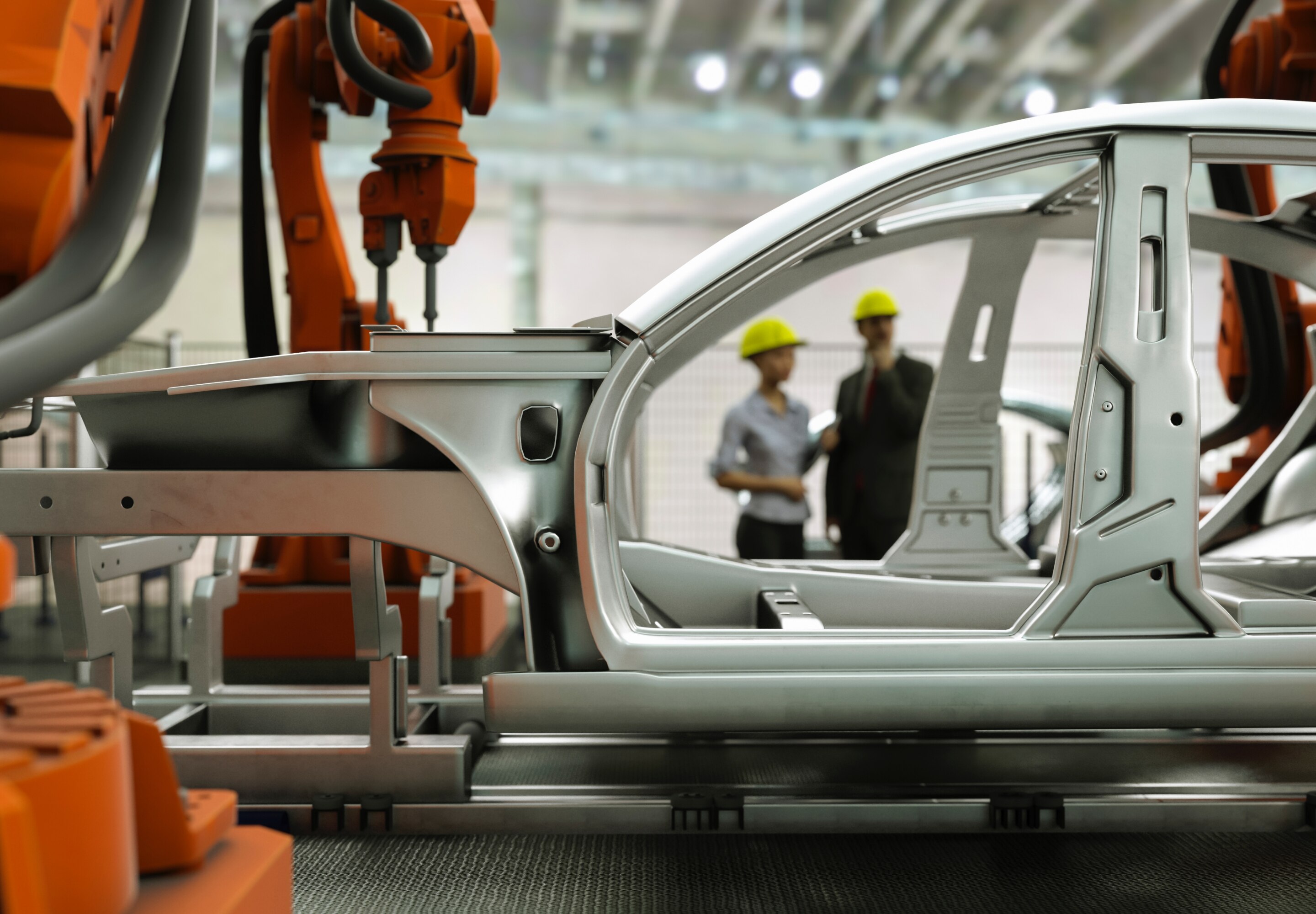 Business professionals standing in a automotive factory