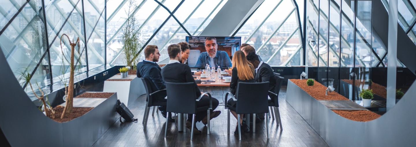 A group of colleagues sitting together around a meeting room table