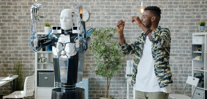 Man standing next to a robot